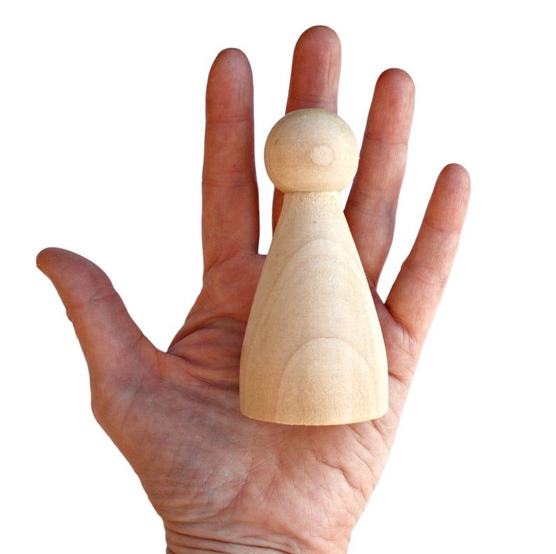 A metaphor for people using hard data in soft skills situations, a female peg dolly in the palm of a human hand
